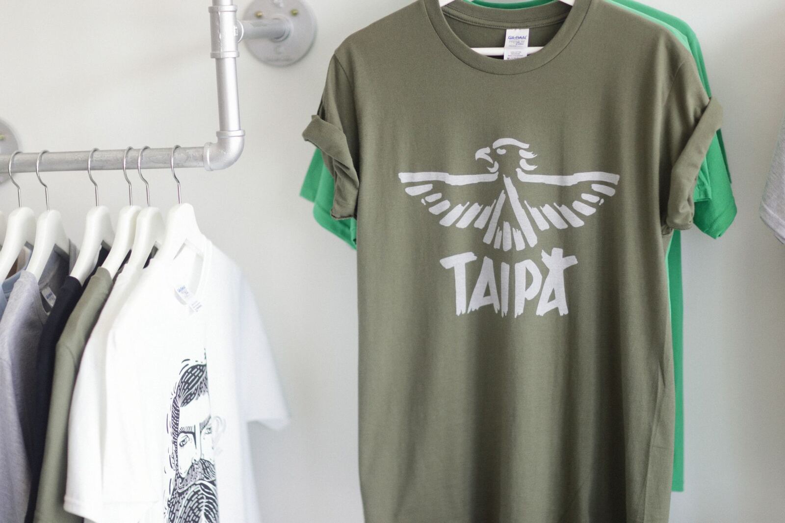 A row of fashionable T-shirts hanging stylishly in a bright retail space.