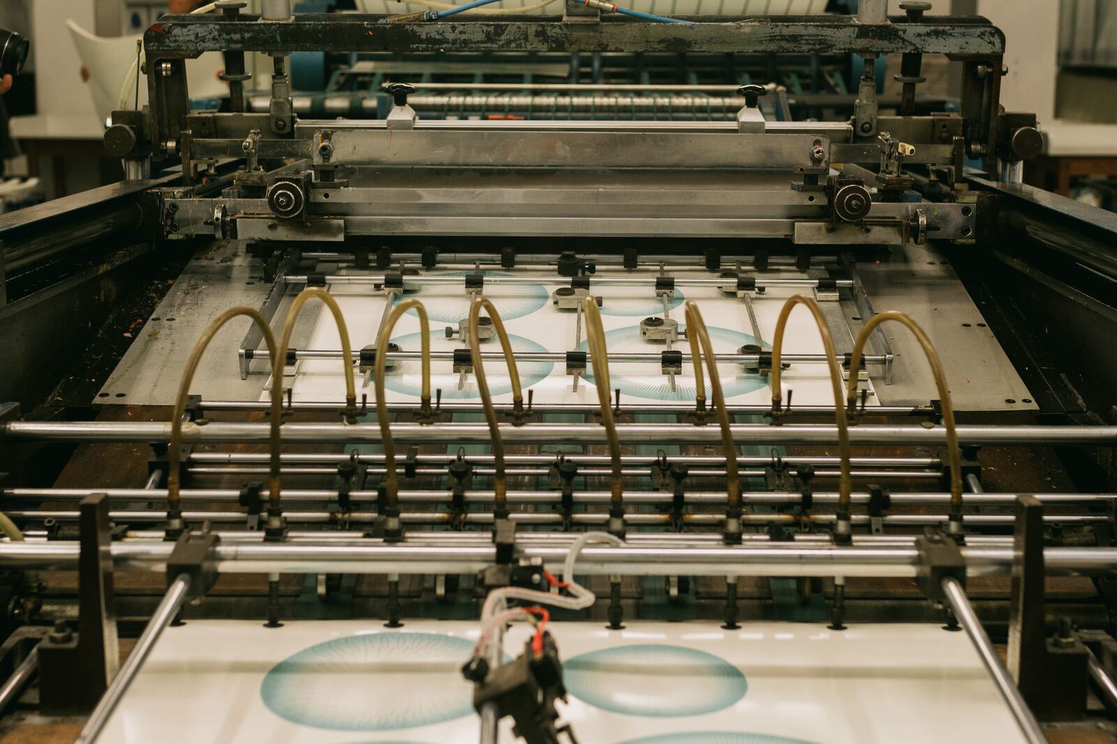 Close-up of an industrial printing press producing designs.